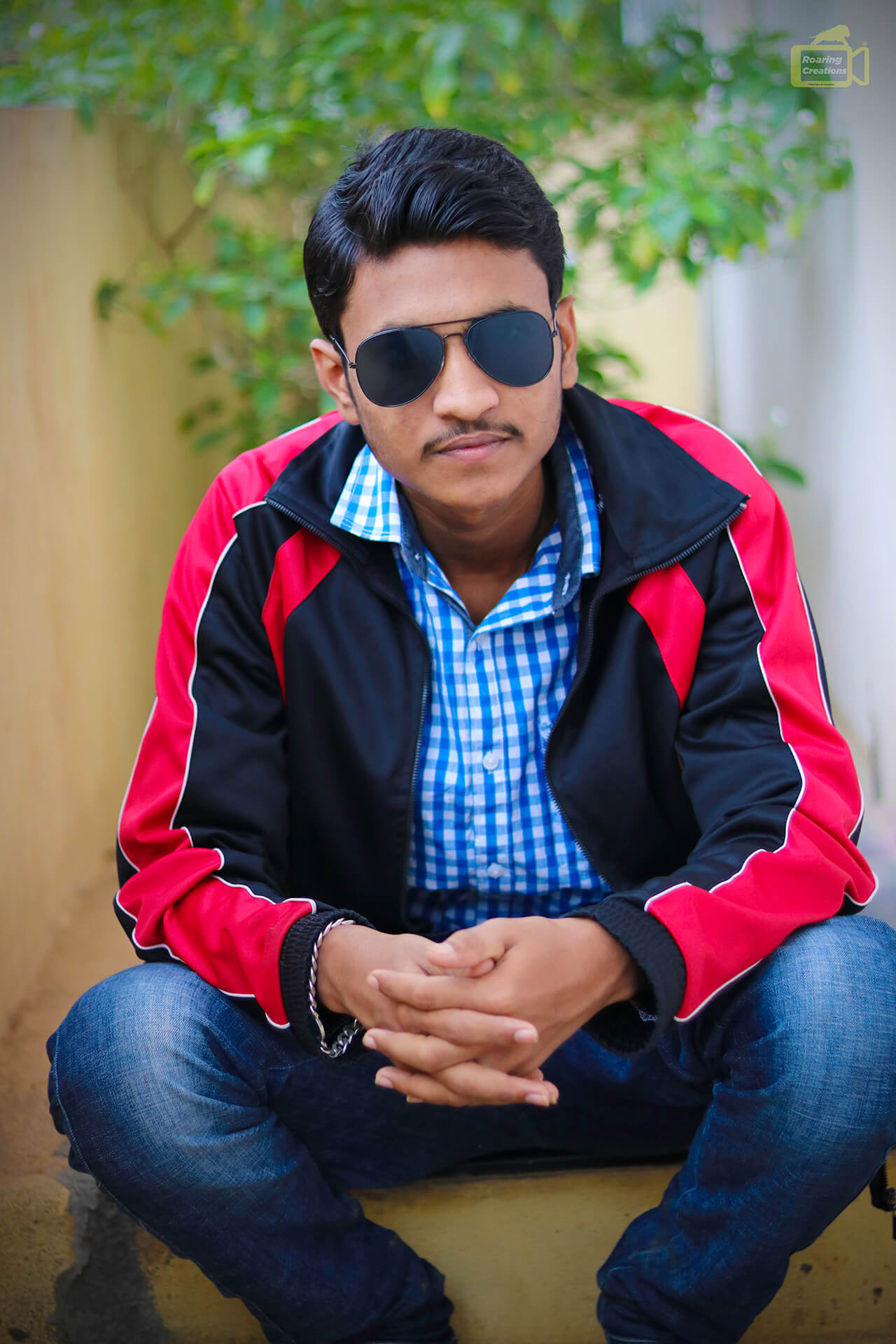 Indian man at red shirt and sunglasses posed outdoor. 10481949 Stock Photo  at Vecteezy